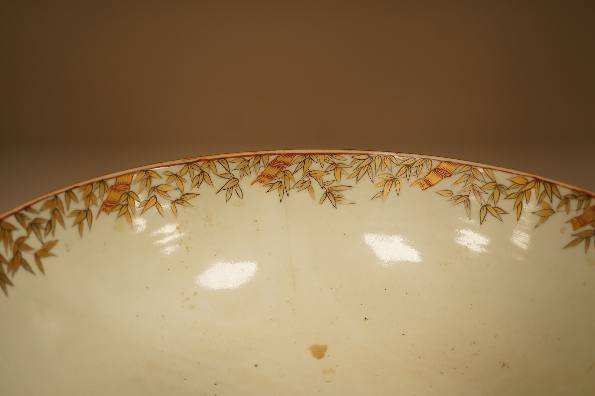 An 18th century Chinese famille rose figural bowl, on wooden stand, 34cm diameter.